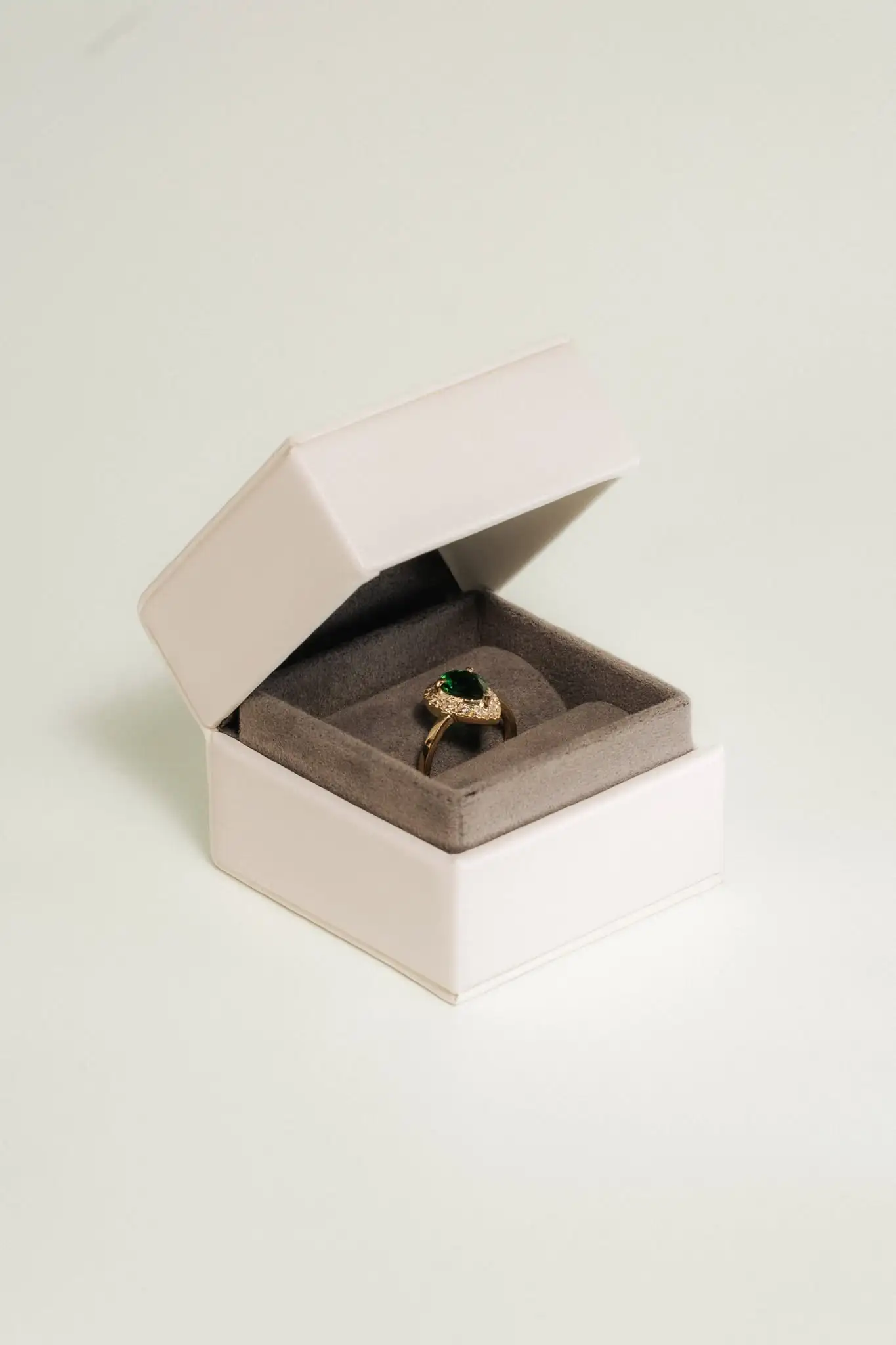 A pear-cut ring with a diamond halo in its box