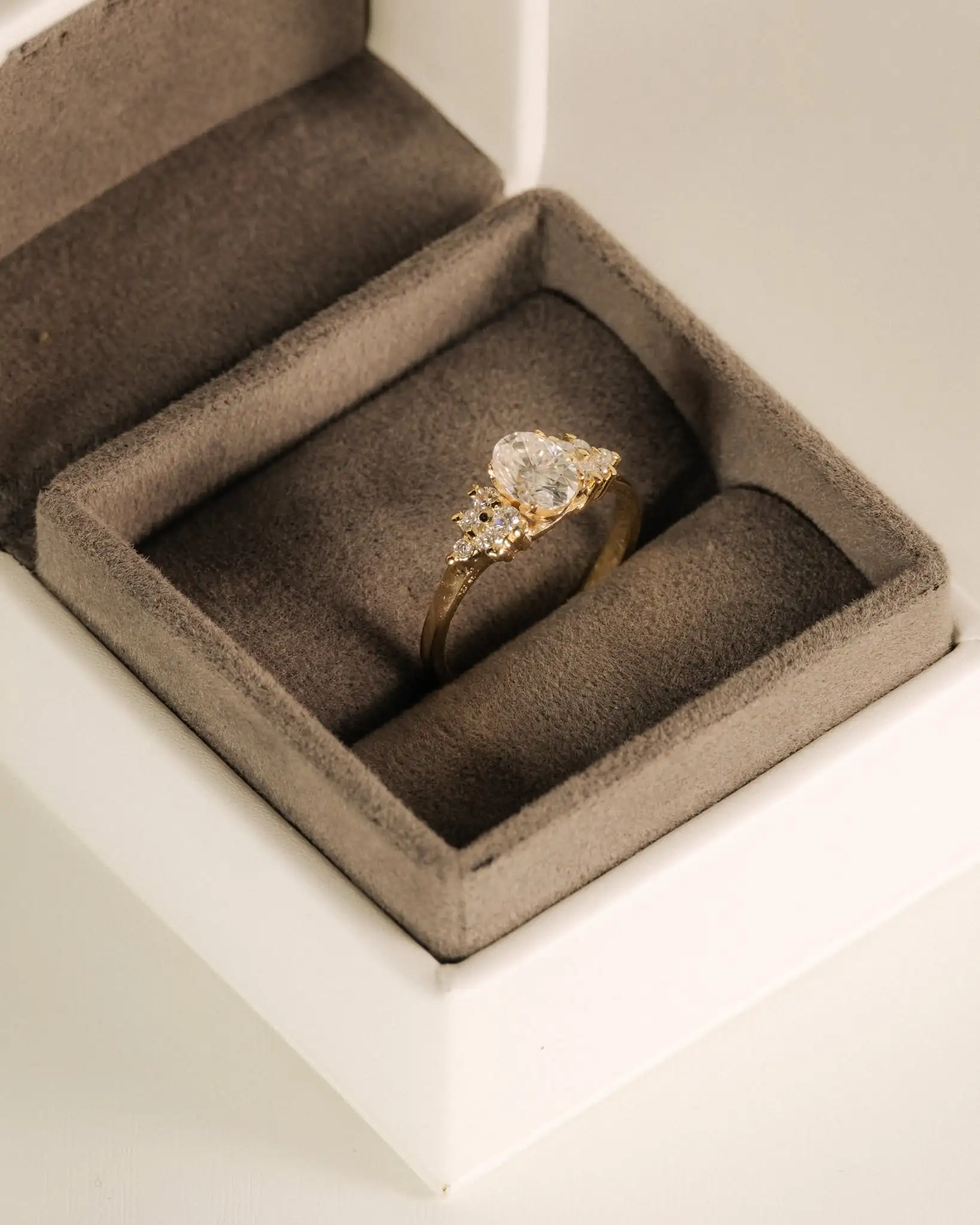 A centre stone flanked by accent stones, in its box