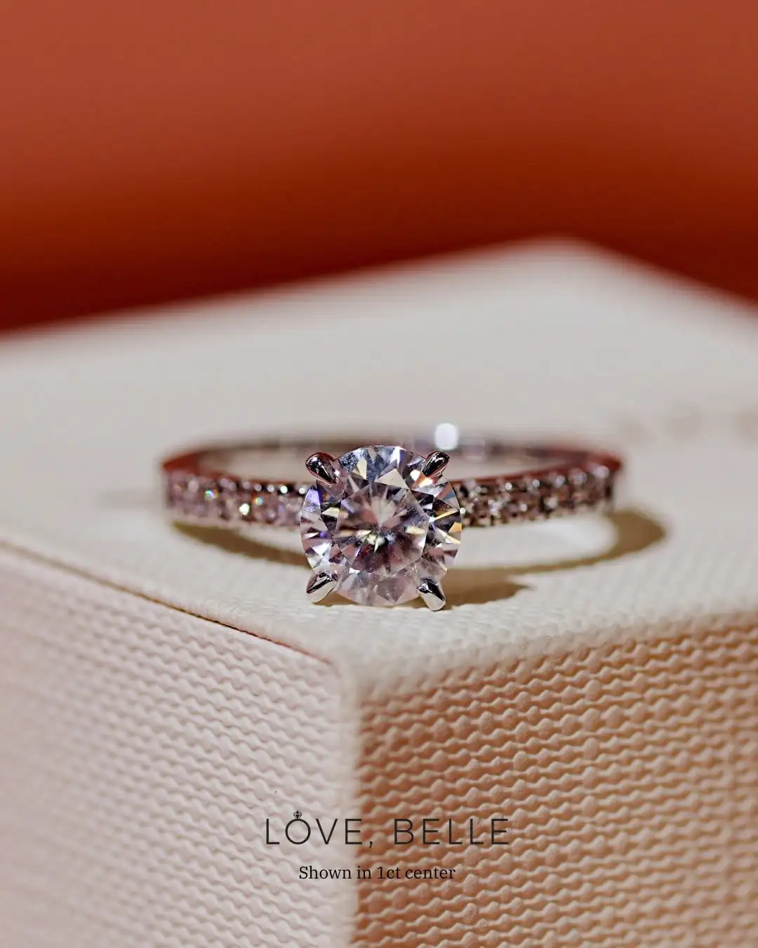 A certified round brilliant centre stone in a pavé setting
