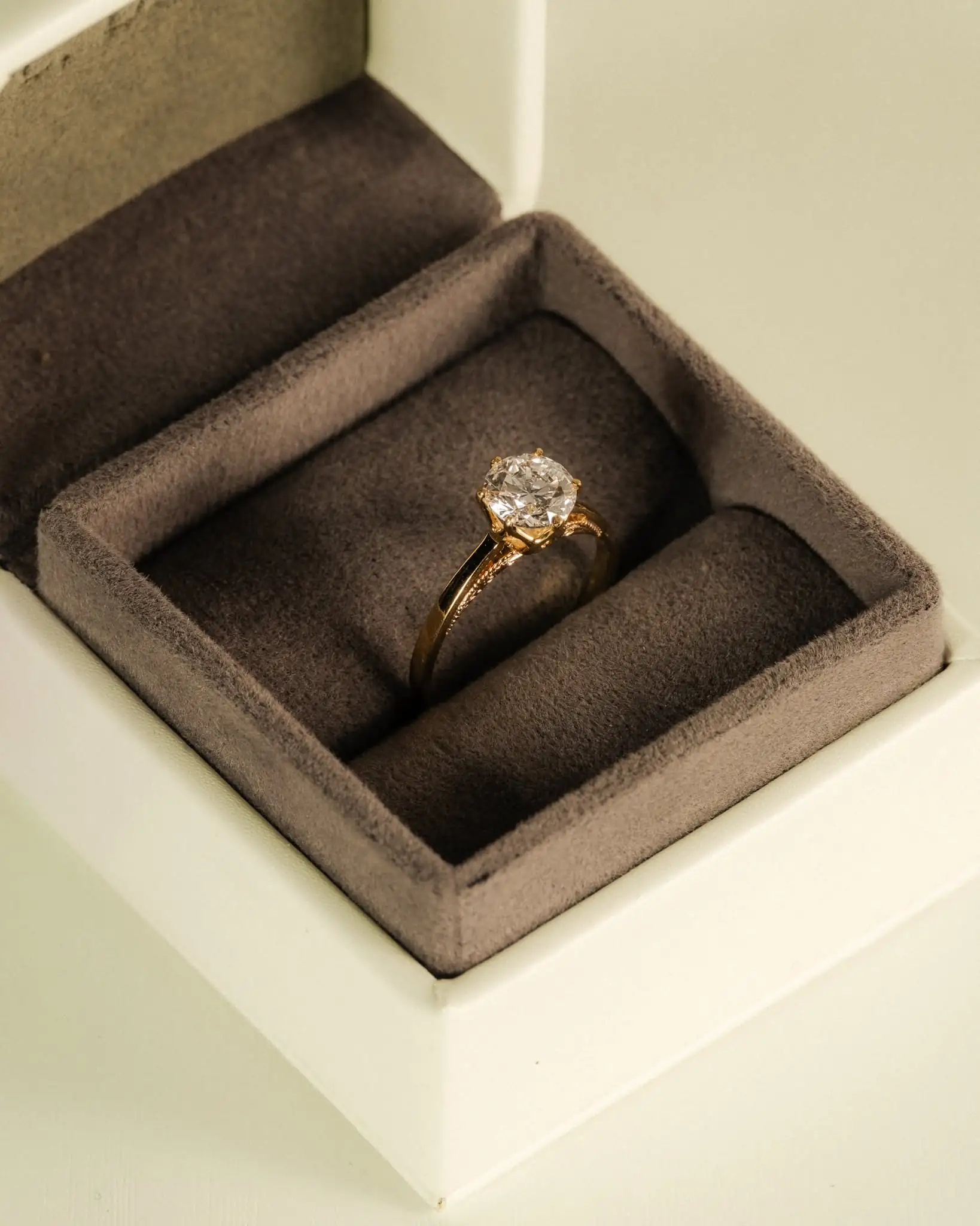 A yellow gold solitaire in its presentation box